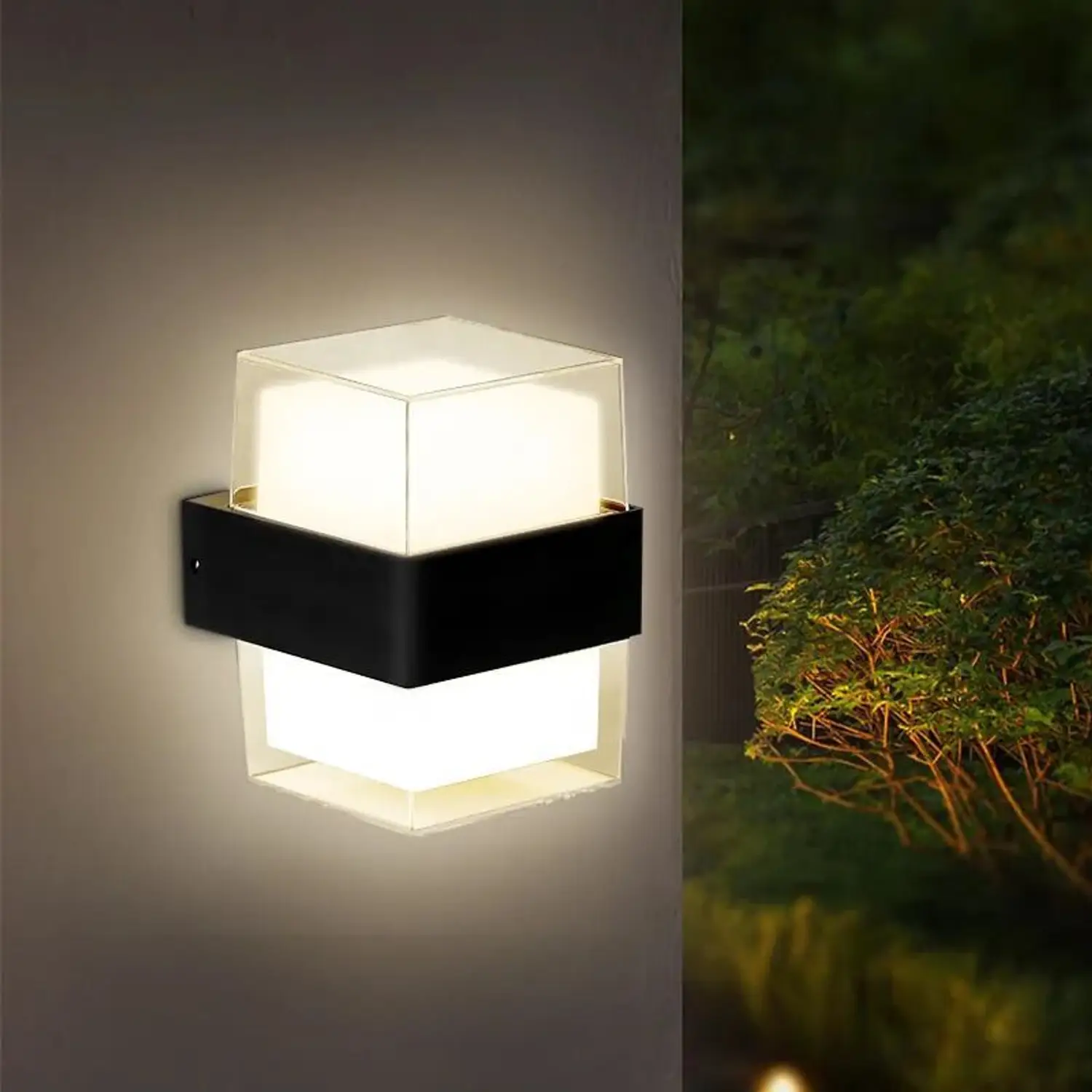 Modern outdoor wall light fixture on a neutral background with a second image of it in a garden setting.