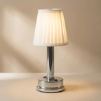 Table lamp with a white shade on a beige background
