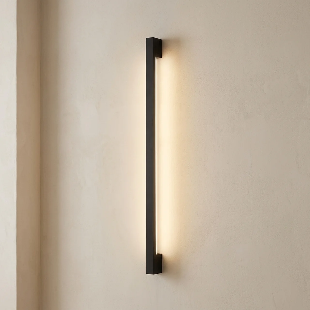 Modern wall-mounted light fixture on a beige wall