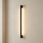 Modern wall-mounted light fixture on a beige wall