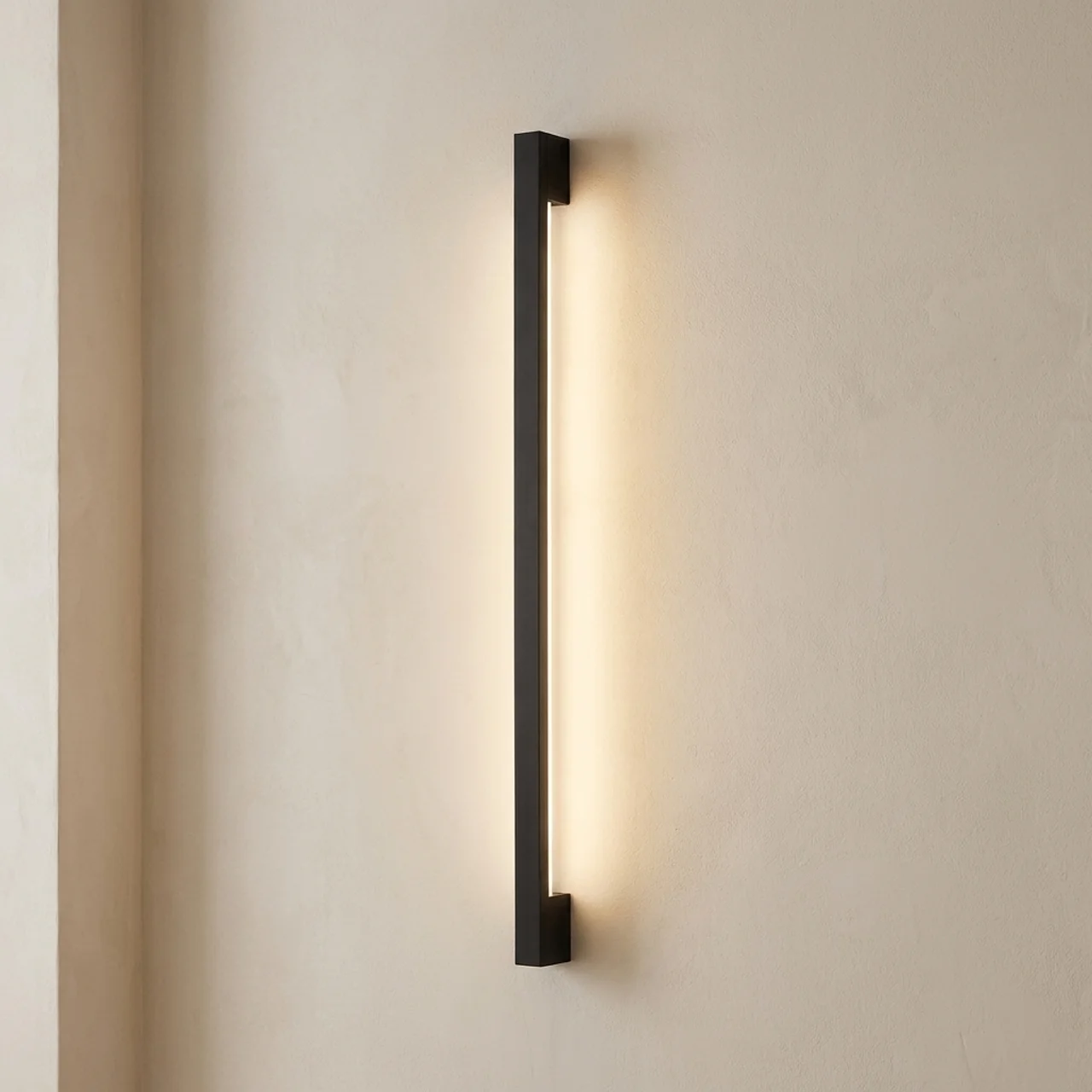 Modern wall-mounted light fixture on a beige wall