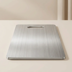 Stainless steel cutting board on a light beige surface