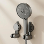 Gray shower head and handheld shower on a beige wall