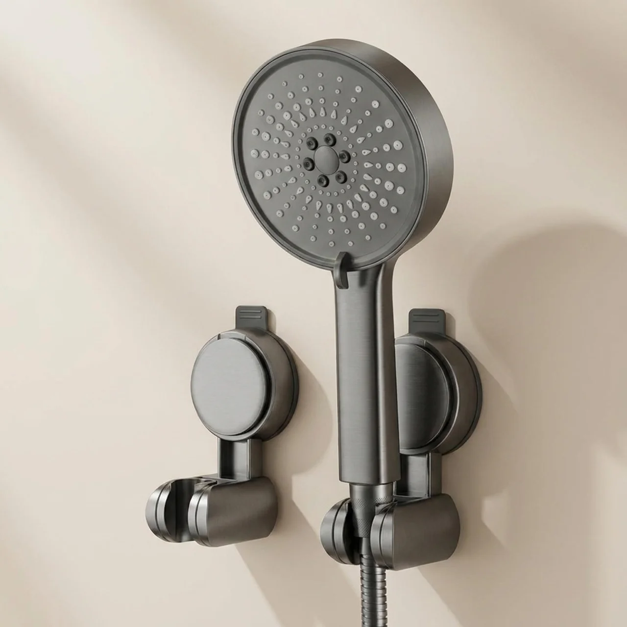 Gray shower head and handheld shower on a beige wall