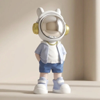 Toy figure wearing a white helmet with gold accents on a beige background