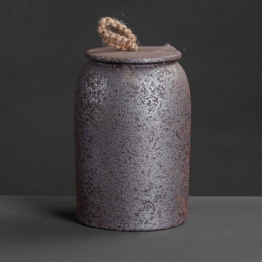 Textured ceramic jar with a rope lid on a dark background