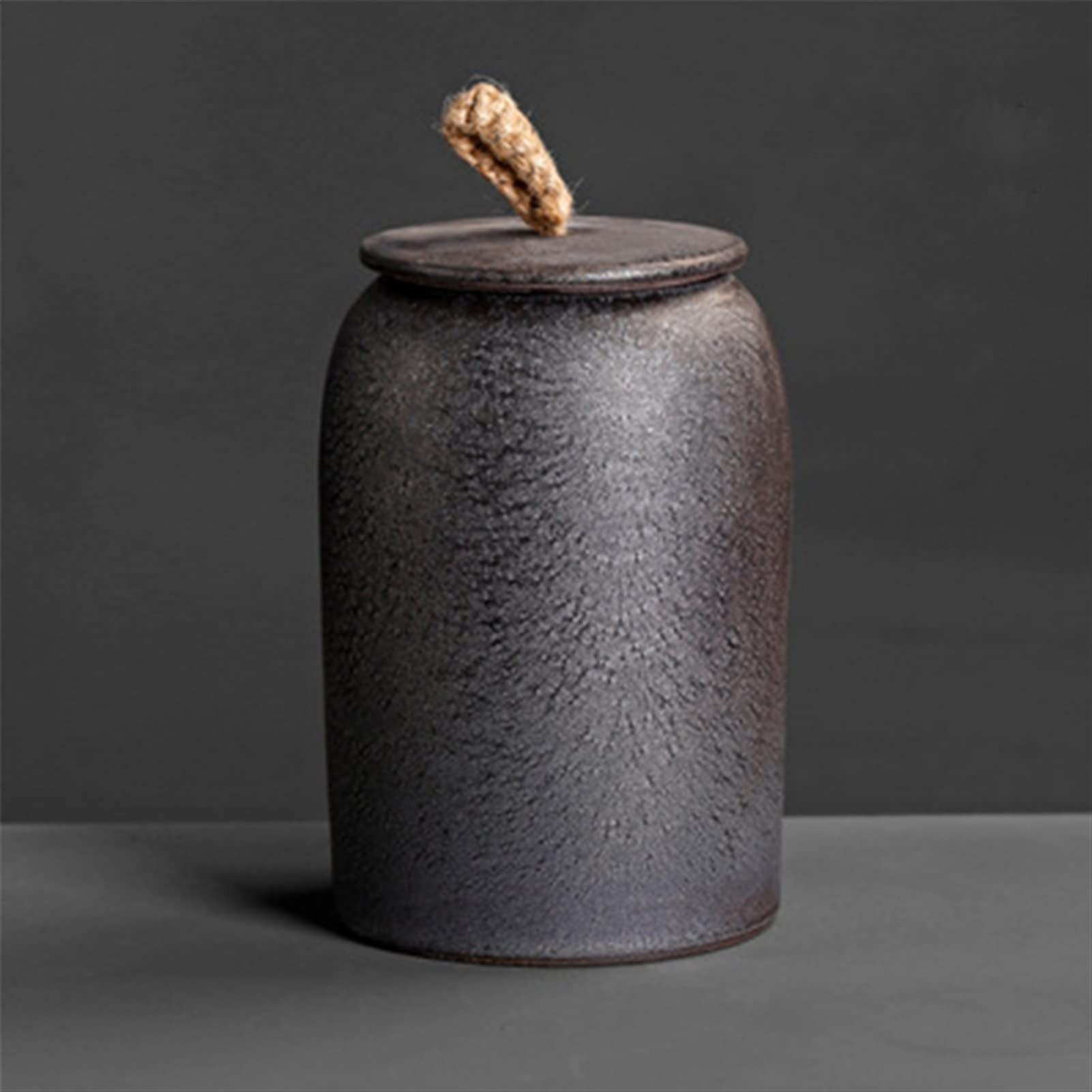 Textured ceramic jar with a lid on a dark background