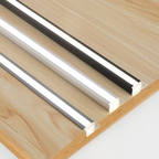 Two metallic profiles on a wooden surface
