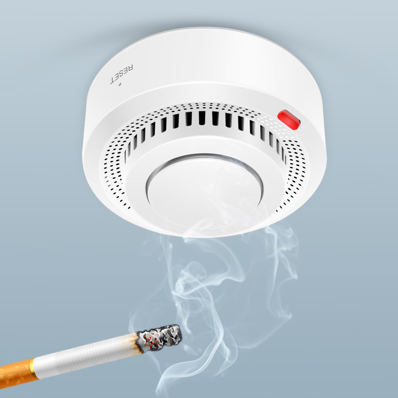 Smoke detector with a lit cigarette producing smoke against a light blue background