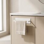Beige towel hanging on a wall-mounted holder next to a light wooden cabinet with a marble countertop.