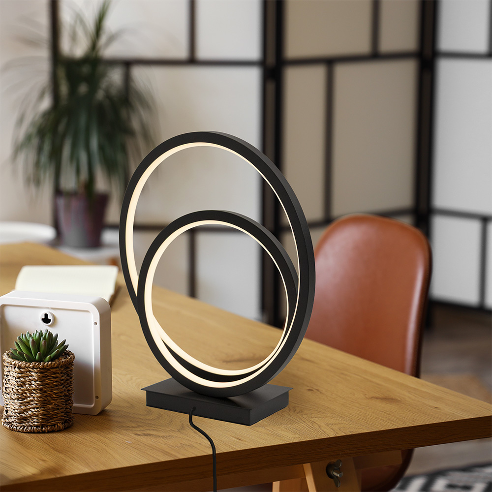 Modern table lamp with circular design on a wooden surface