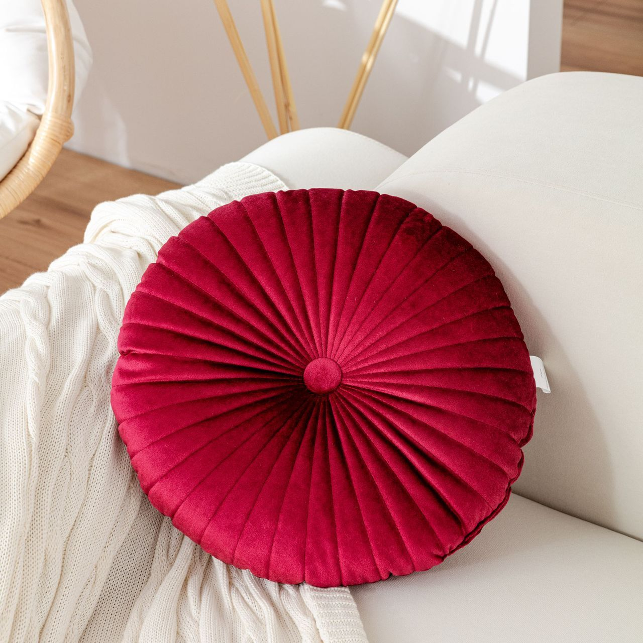 Red pleated cushion on a white chair
