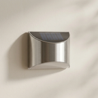 Solar wall light fixture on a beige wall