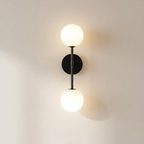 Wall-mounted lamp with two round lights on a plain wall