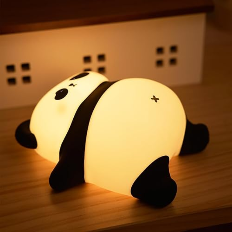Cute panda-shaped night light on a wooden surface