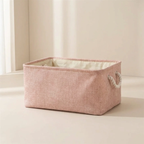 Pink storage basket with handles on a light surface