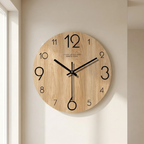 Wooden wall clock with black hands on a beige wall