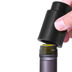 Black cylindrical container with a hand opening it on a white background