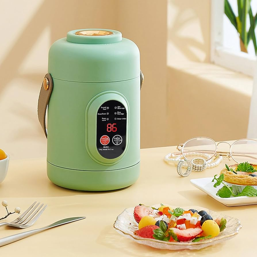 Green thermos jar on a table with a salad and glasses in the background