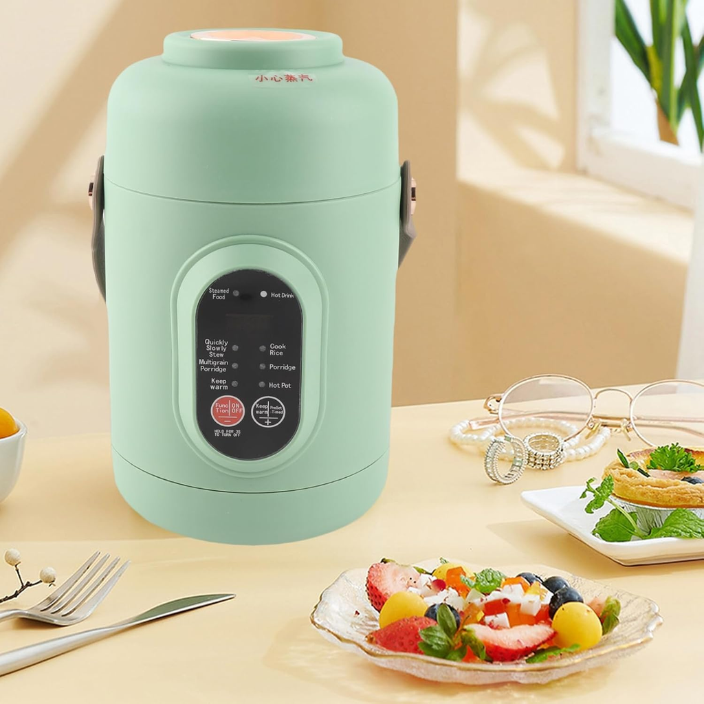 Green food warmer on a table with a salad and glasses in the background