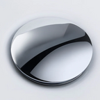 Round metallic object on a light gray background