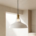 White pendant light with gold fixture hanging in a room with neutral walls.