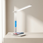 Modern LED desk lamp with wireless charging pad on a neutral background