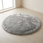 Round gray fluffy rug on a light wooden floor.