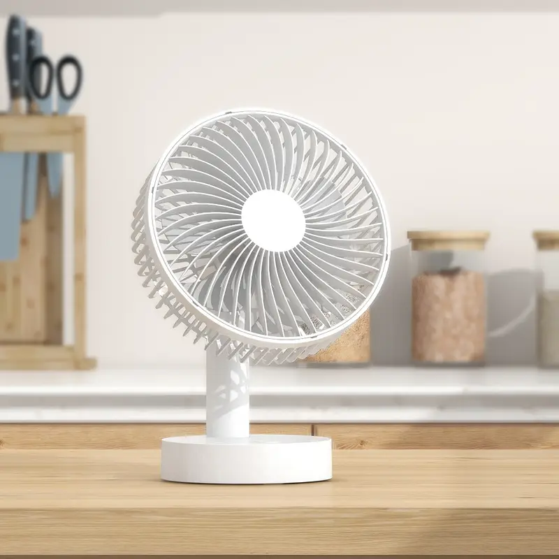 White desk fan on a wooden surface with a neutral background