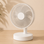 White desk fan on a wooden surface with a beige background