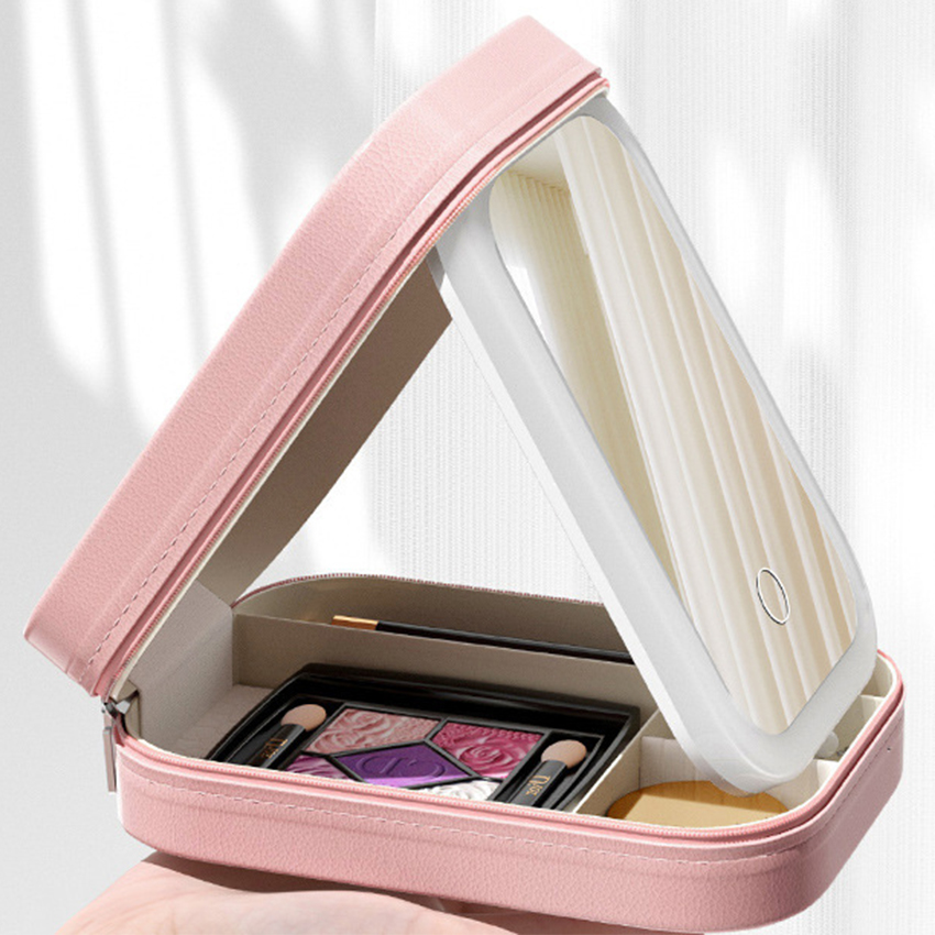 Pink makeup case with open lid showing cosmetics on a white background