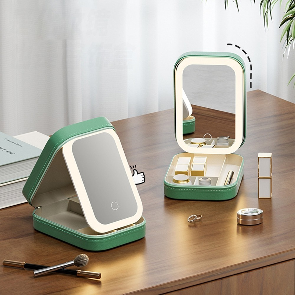 Green makeup mirror with LED lights on a wooden surface
