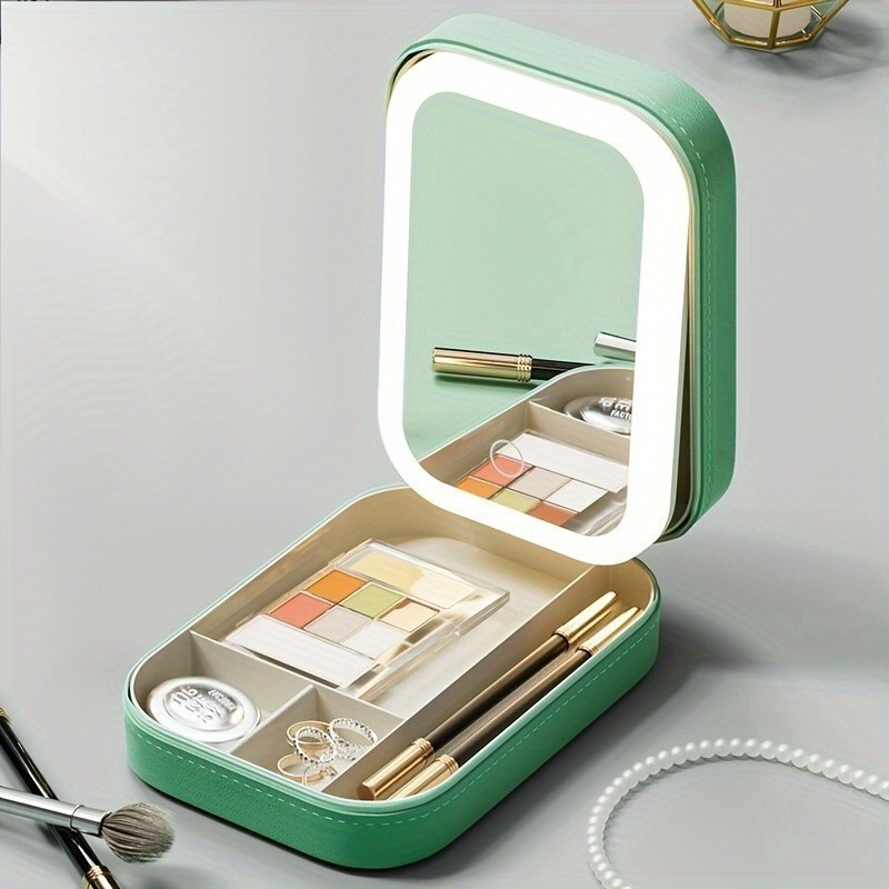 Green makeup case with a mirror and various cosmetic items on a gray background