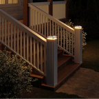 Outdoor staircase with illuminated railings and steps at night.