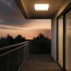 Balcony with a view of a sunset over trees, illuminated by a ceiling light.