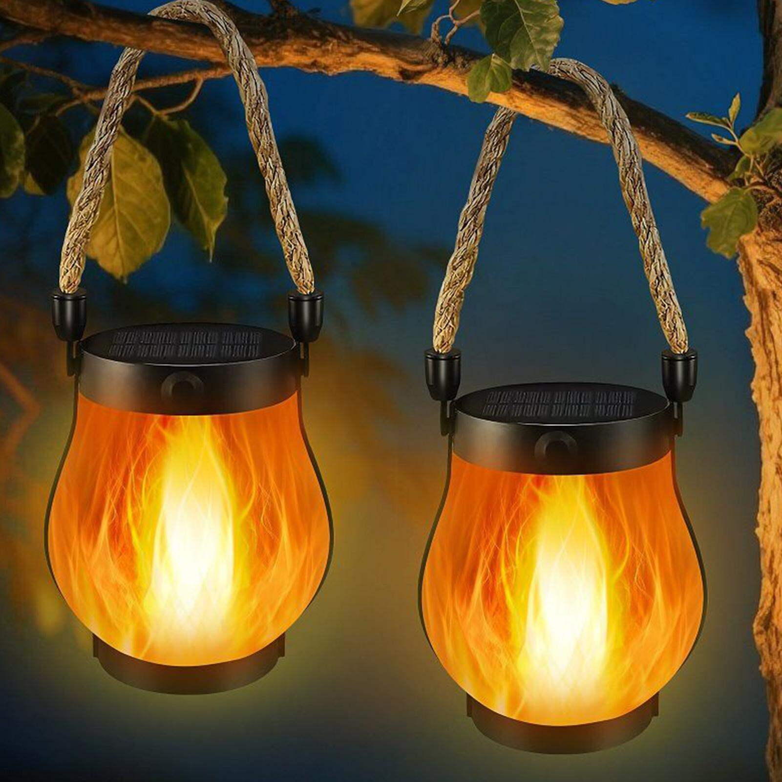 Two flame-patterned solar lanterns hanging from a branch with a blurred natural background.