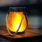Solar lantern with flame design on a wooden surface