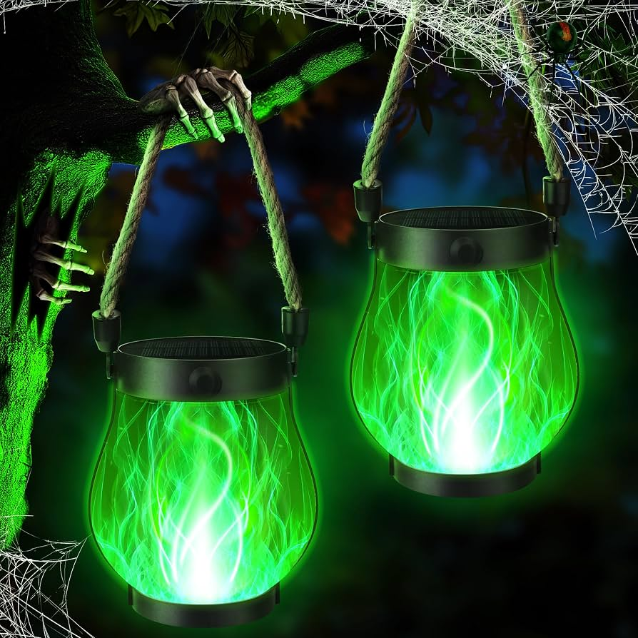 Two green glowing lanterns with a spooky hand and spider web in the background.