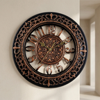 Decorative wall clock with intricate design on a plain wall.