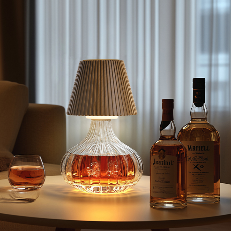 WILNT rechargeable cordless table lamp on a table with a glass of whiskey and a bottle in a cozy room setting.