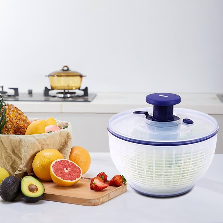 Salad spinner on a kitchen counter with fruits and vegetables