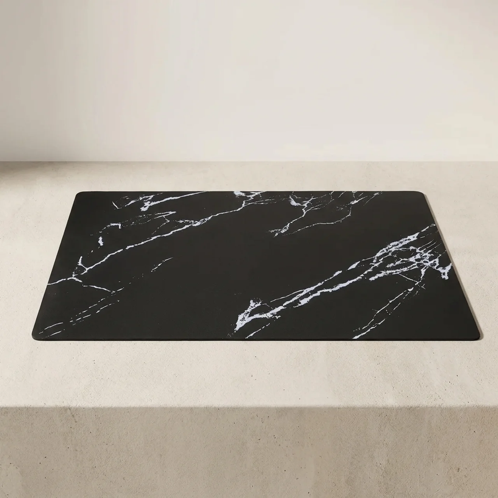 Black marble-patterned mat on a light gray surface