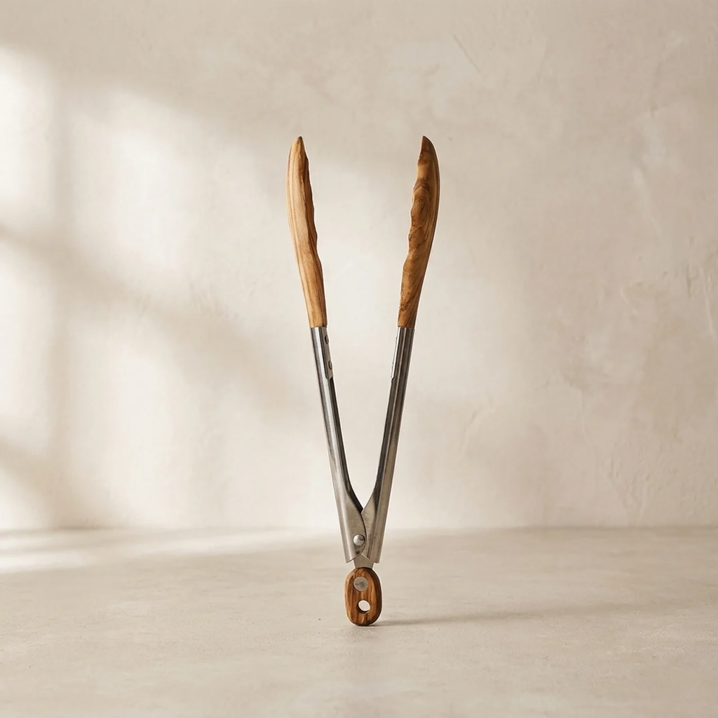 Wooden-handled tongs on a beige background