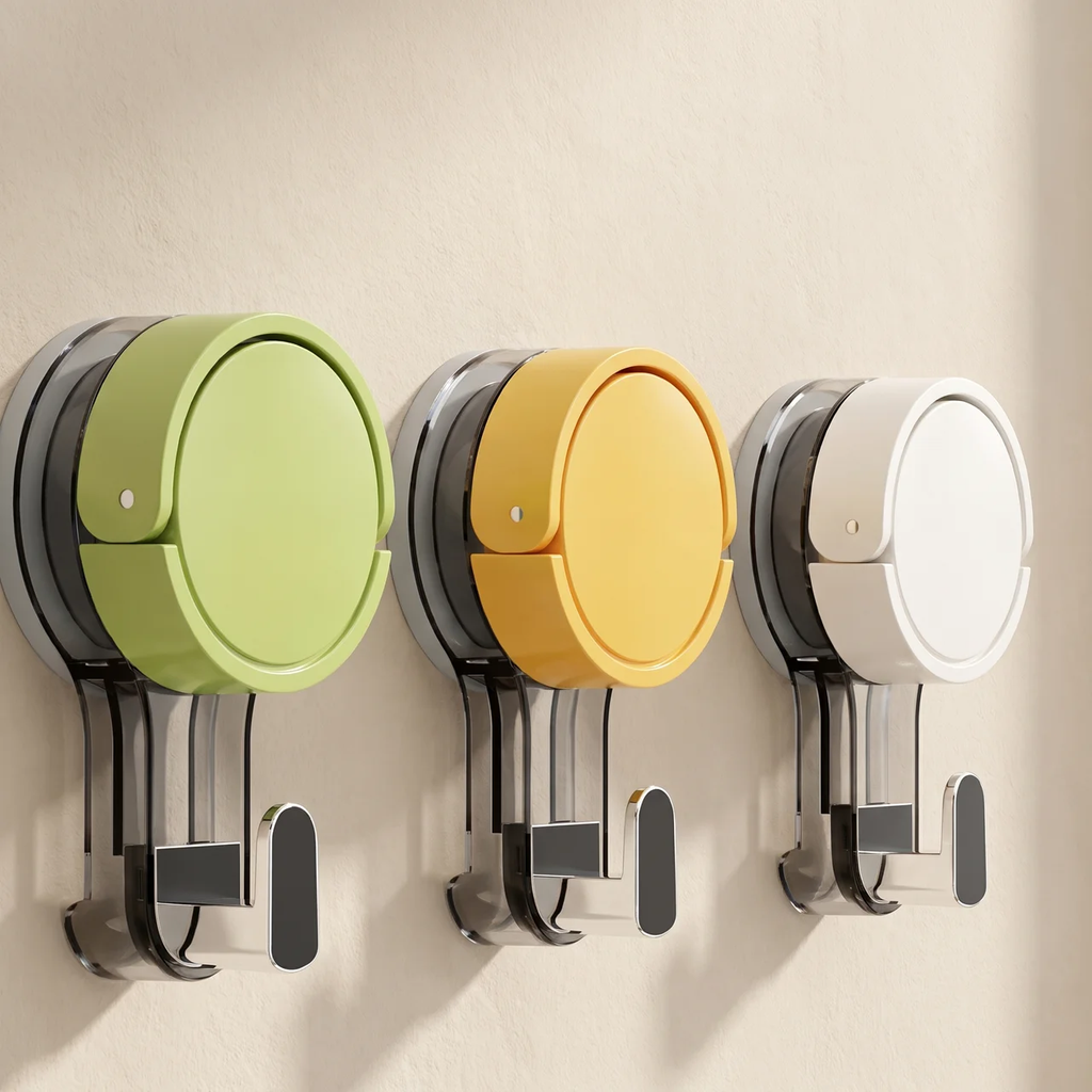 Three wall-mounted hook-and-hold storage holders in light green, mustard yellow, and white, shown against a plain beige wall.