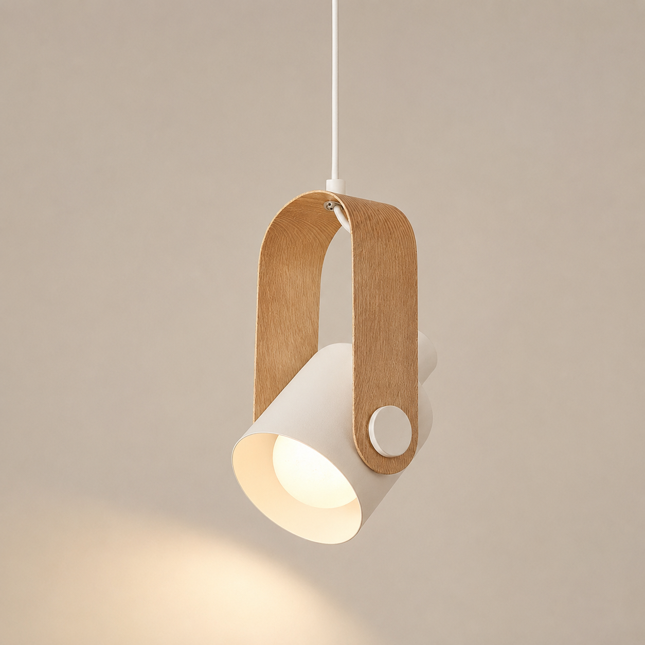 A modern pendant light with a white cylindrical shade, a white circular button, and a natural wood U-shaped frame, suspended by a thin white cord against a warm beige background.
