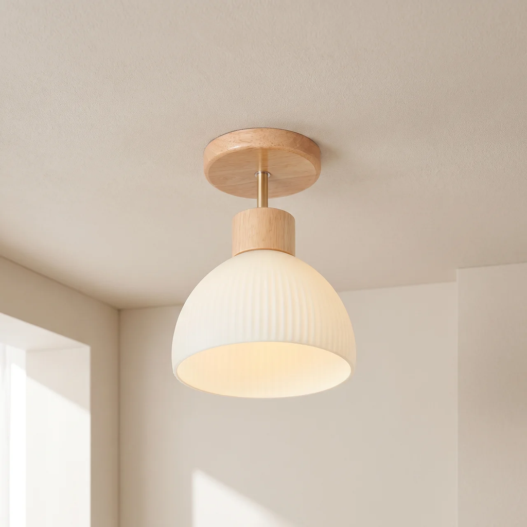 A modern semi-flush mount ceiling light fixture with a ribbed white glass dome shade and natural light wood accents, shown installed on a textured beige ceiling in a minimalist room.