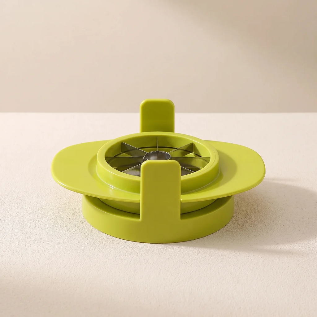 A bright lime green plastic kitchen utensil, likely a garlic press or food processor attachment, shown on a neutral beige background.