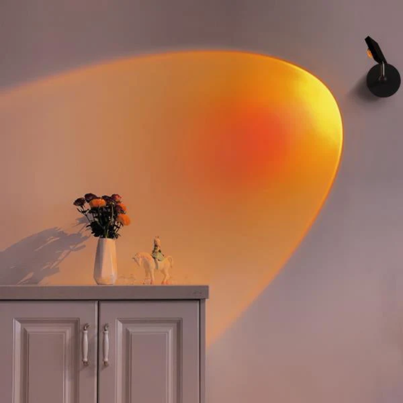 Cabinet with a vase of flowers and a small statue, illuminated by a warm light on a gray wall.