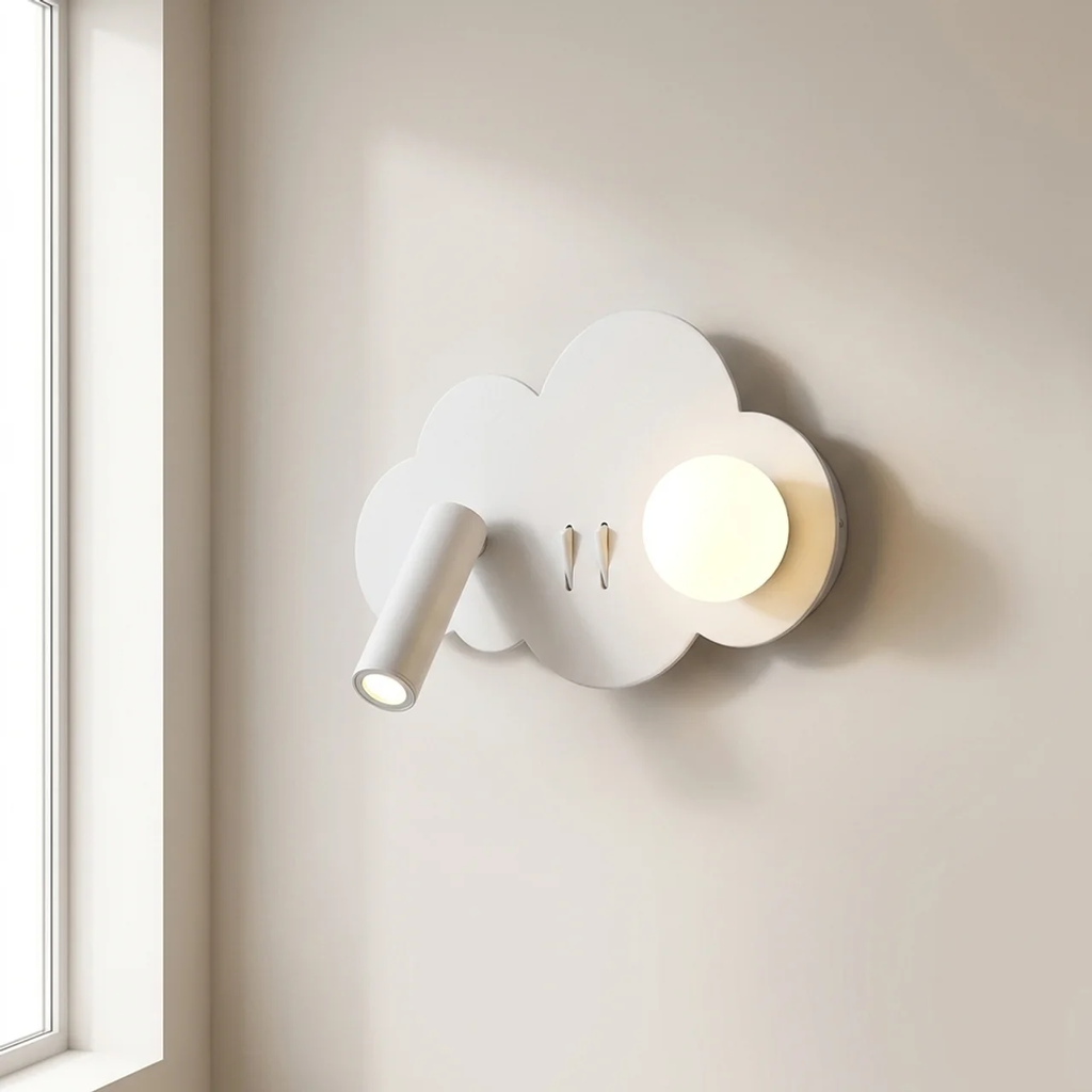 A white cloud-shaped wall sconce with a built-in spotlight and a round glowing bulb, mounted on a beige wall next to a window.
