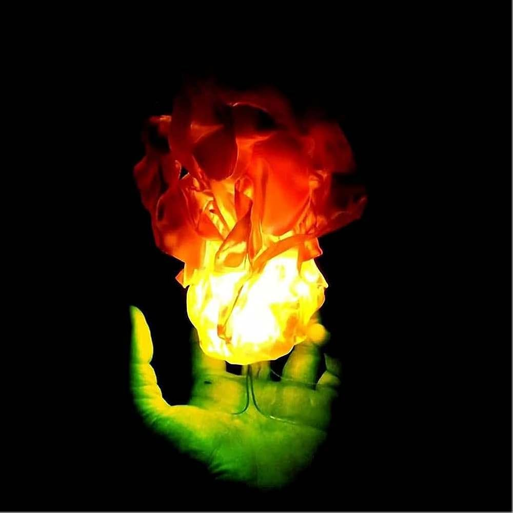 A glowing flame-shaped light or lamp held above a green hand against a solid black background.